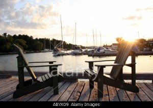 Georgian-Bay-Canada-yachts-in-harbor-Two-Adirondack-chairs-on-landing-ABYX09